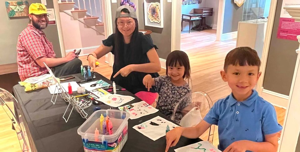A Family doing crafts during Free Sunday at the Museums