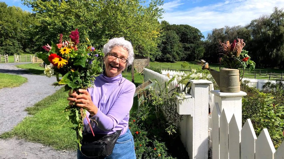 Guest showing off wildflowers she chose from the You Point, We Pick program at Burnside Gardens