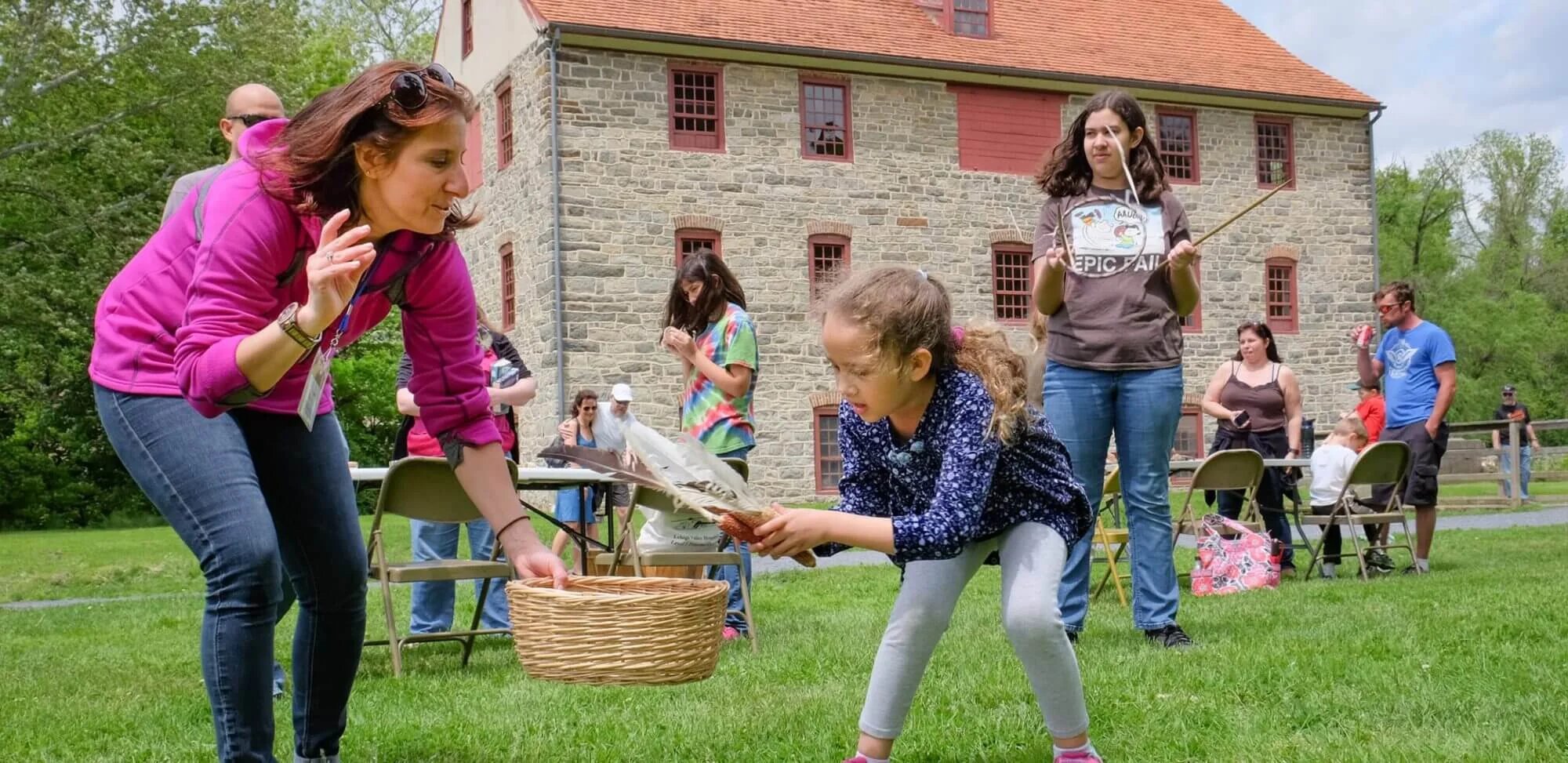 A child plays historic games in the Colonial Industrial Quarter