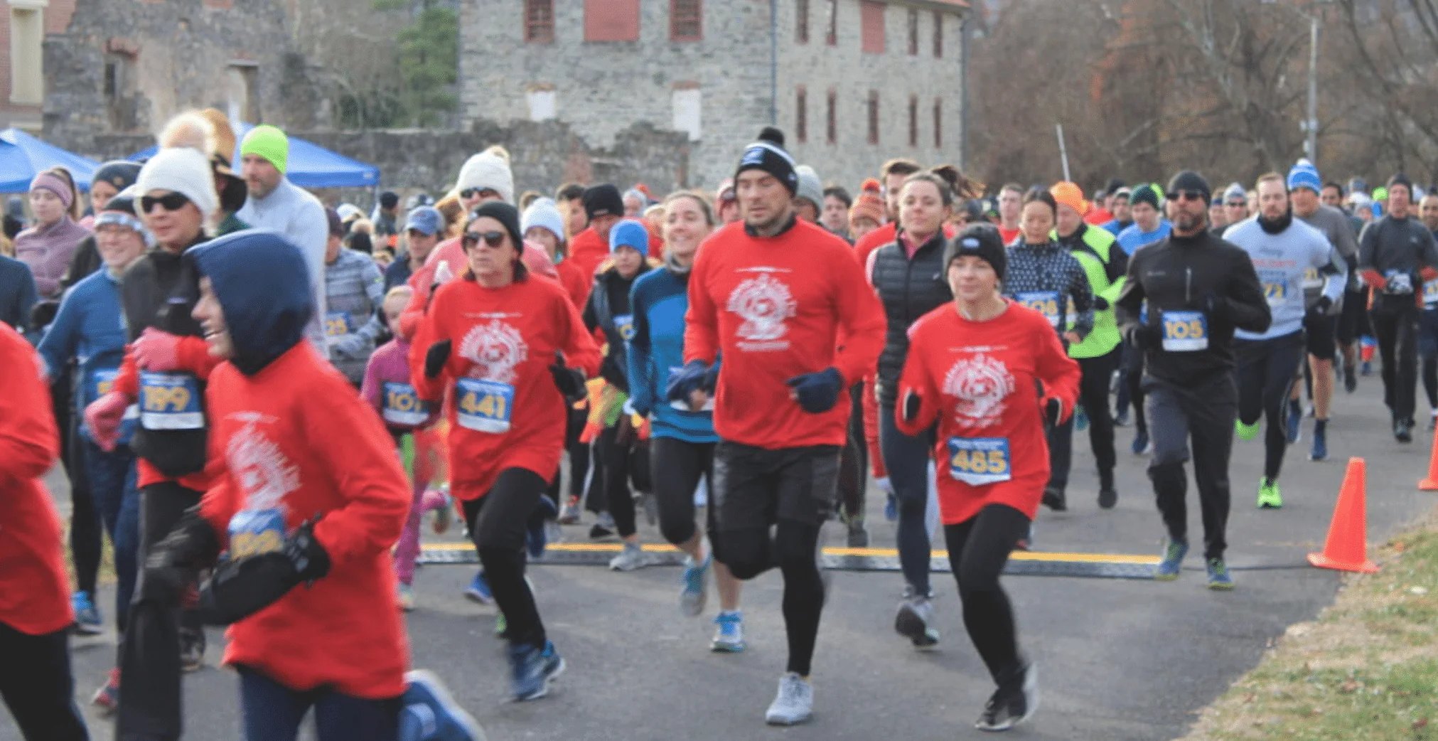 Turkey Trot runners at start line with Tannery in the background